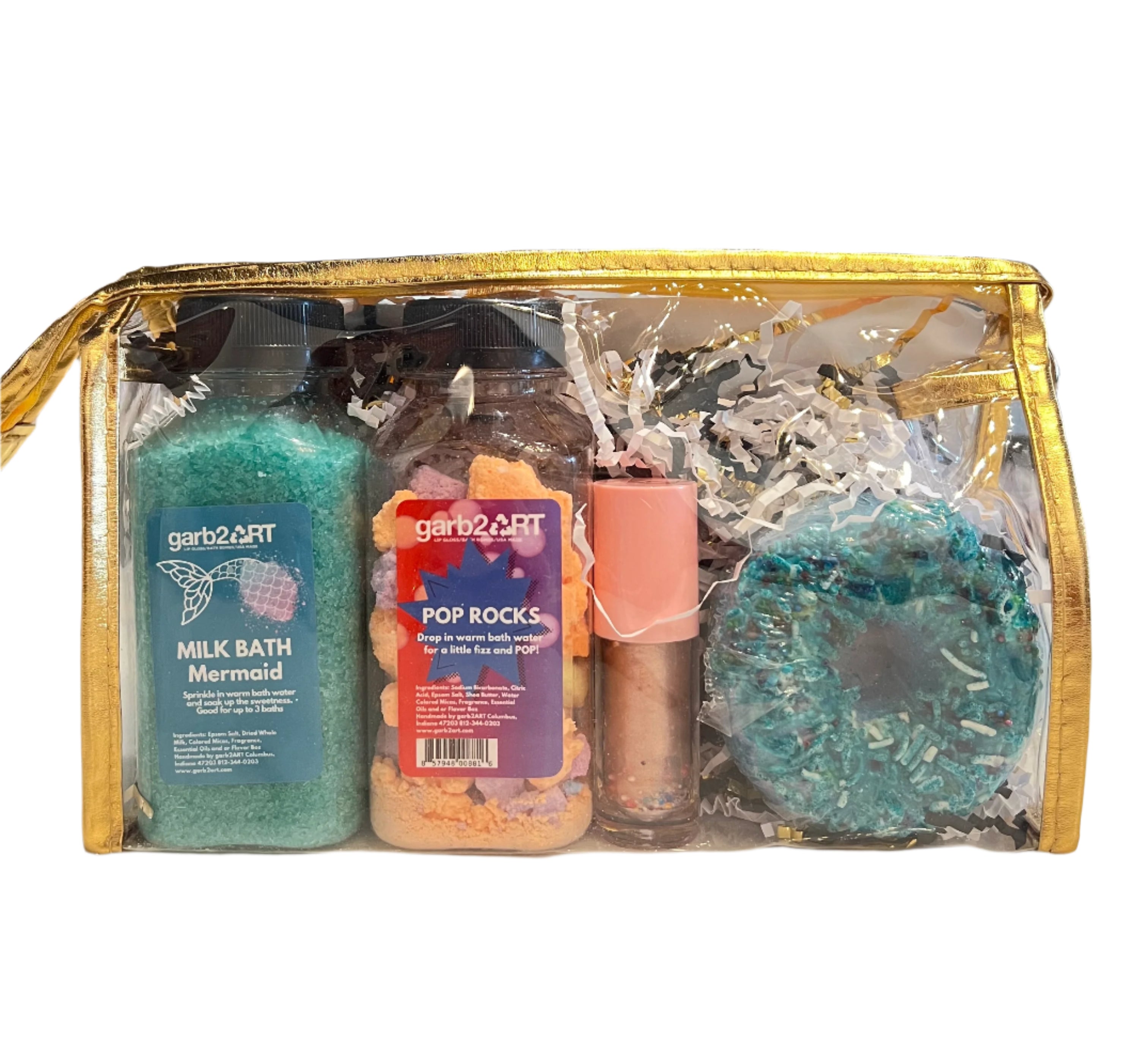Clear makeup bag with bath salts, lip balm, donut bath balm, and milk bath