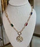 Necklace with colorful gemstones and a gold medallion 