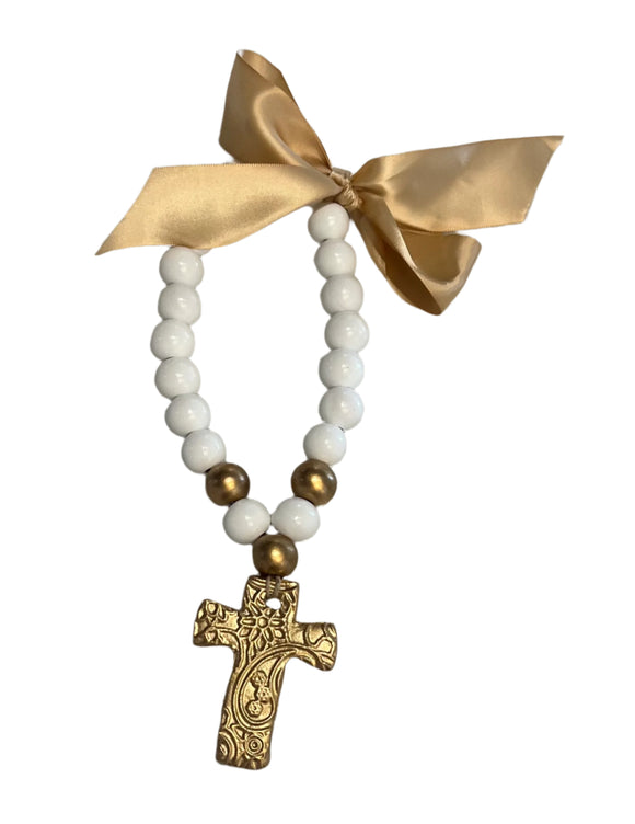 Necklace with white blessing beads, gold cross, and gold bow 