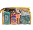 Clear makeup bag with bath salts, lip balm, donut bath balm, and milk bath