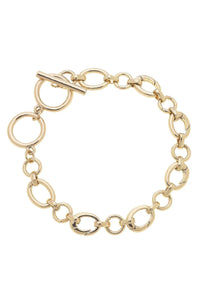 Gold chain charm bracelet with a toggle clasp 