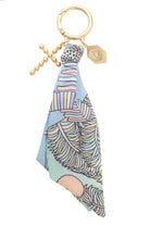 Keychain with a colorful patterned scarf and gold chain with cross and  gem charms.