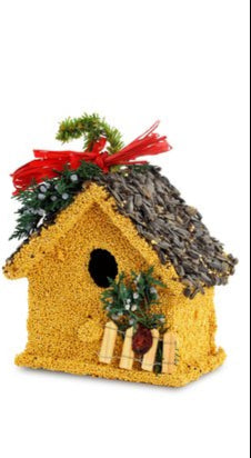 Decorative birdhouse with a red bow and greenery 
