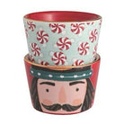 Set of two ceramic pots with decorative designs, one featuring a nutcracker face and the other with peppermint pattern.